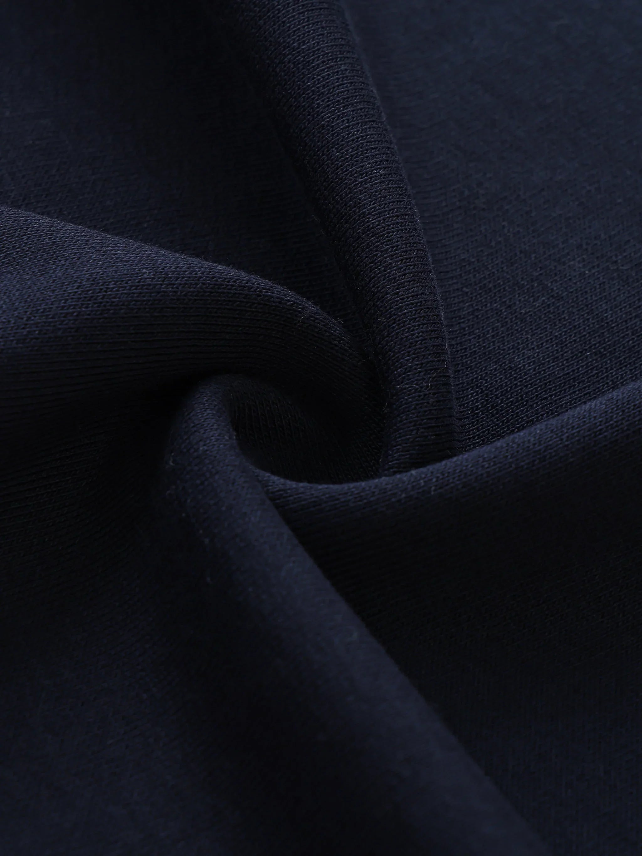 Close-up of heavyweight navy blue streetwear fabric with soft texture and visible weave