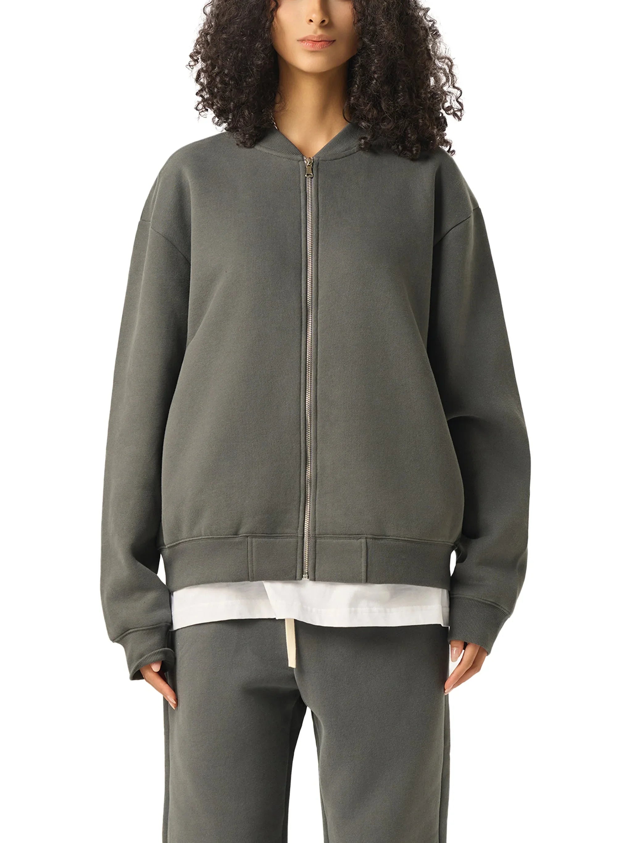 Woman wearing oversized zip-up heavyweight grey sweatshirt and matching sweatpants