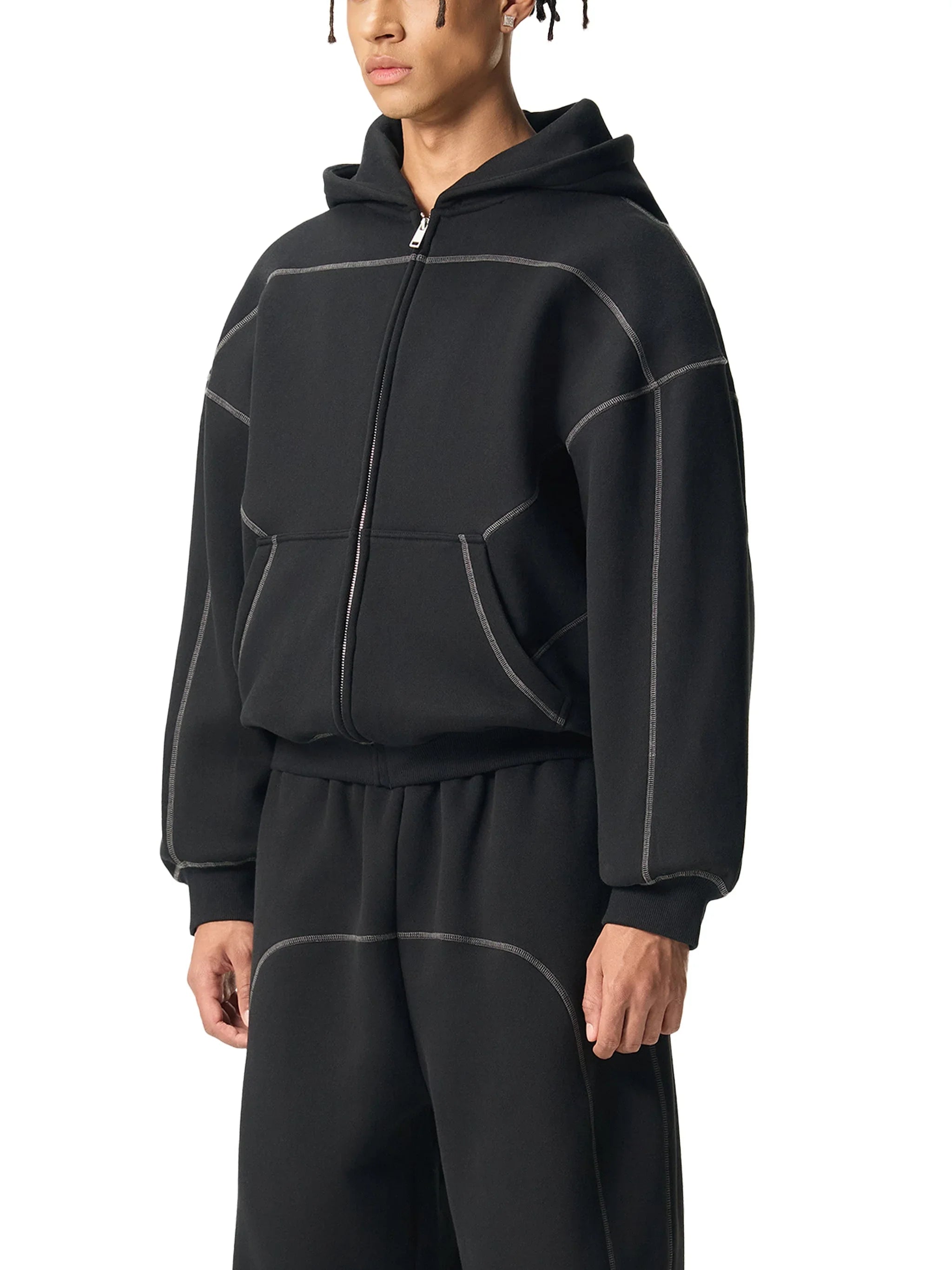 Man wearing black heavyweight zip-up hoodie and matching sweatpants with contrast stitching