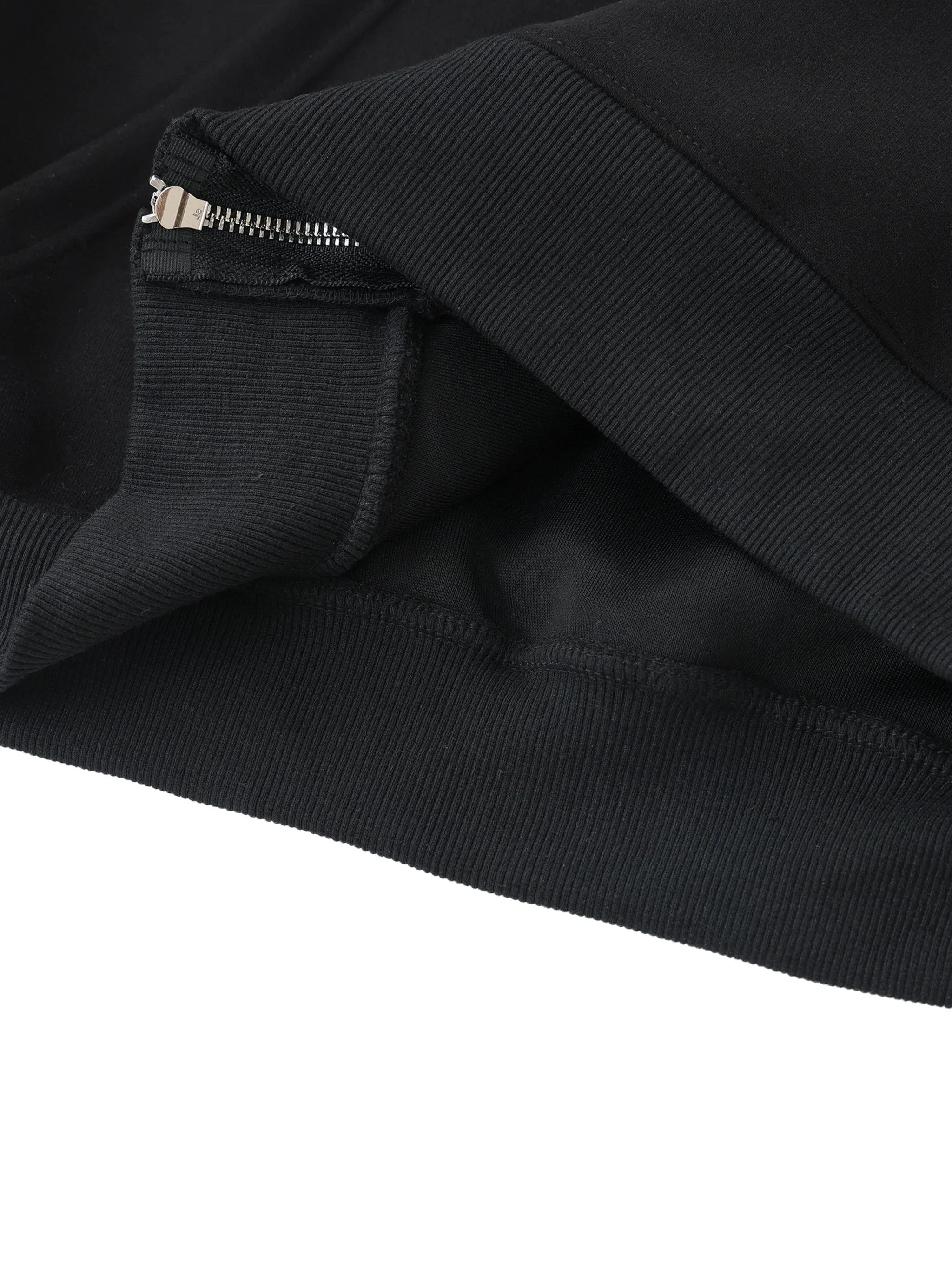 Close-up of heavyweight black hoodie with metal zipper and ribbed hem