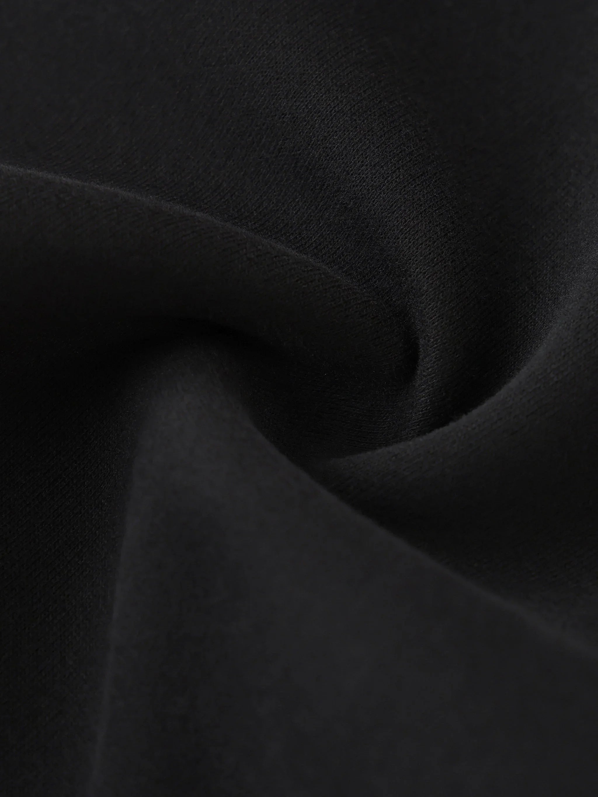 Close-up of soft heavyweight black fabric with smooth texture and natural folds