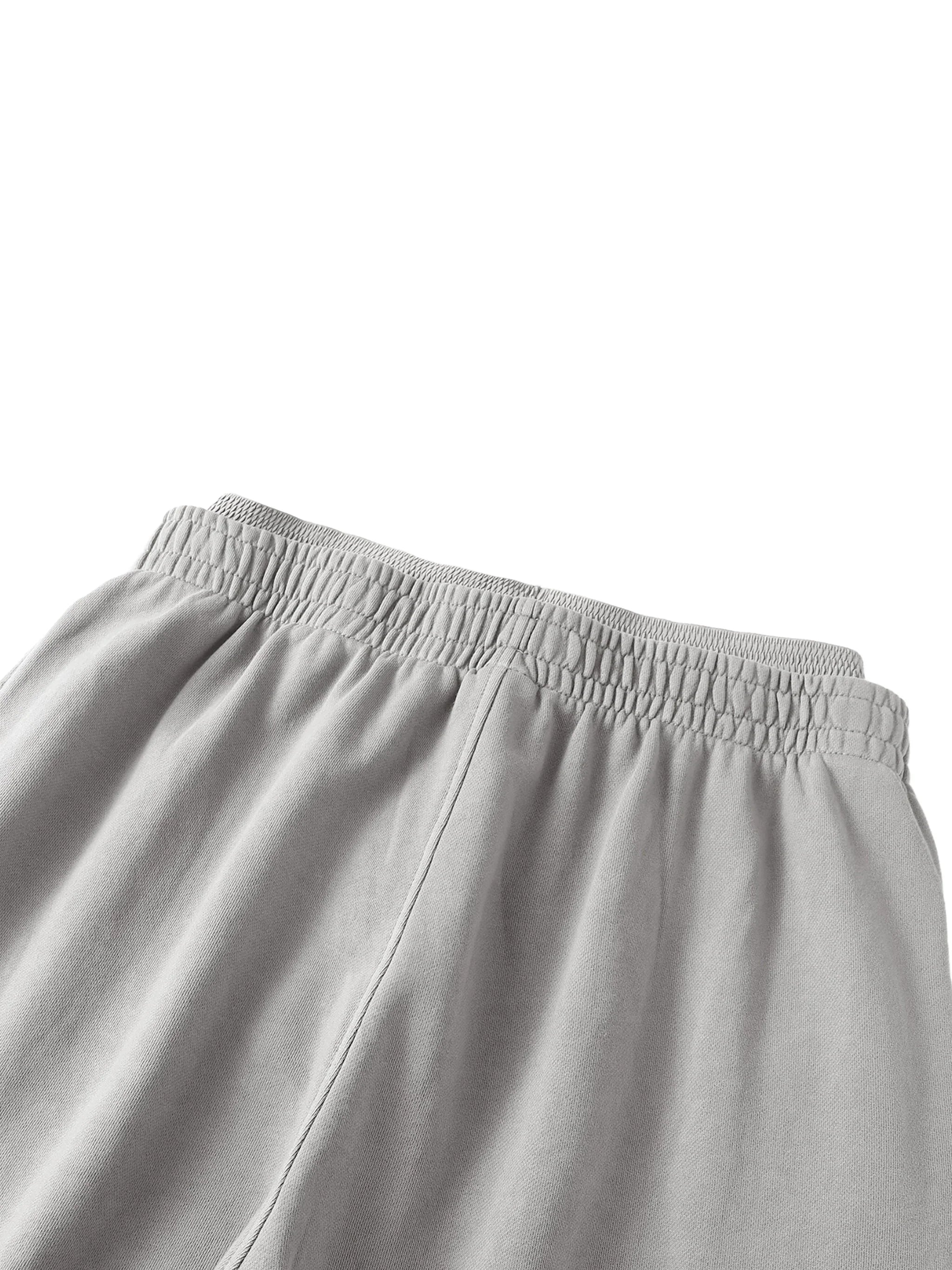 Close-up of grey heavyweight sweatpants with elastic waistband, streetwear essentials