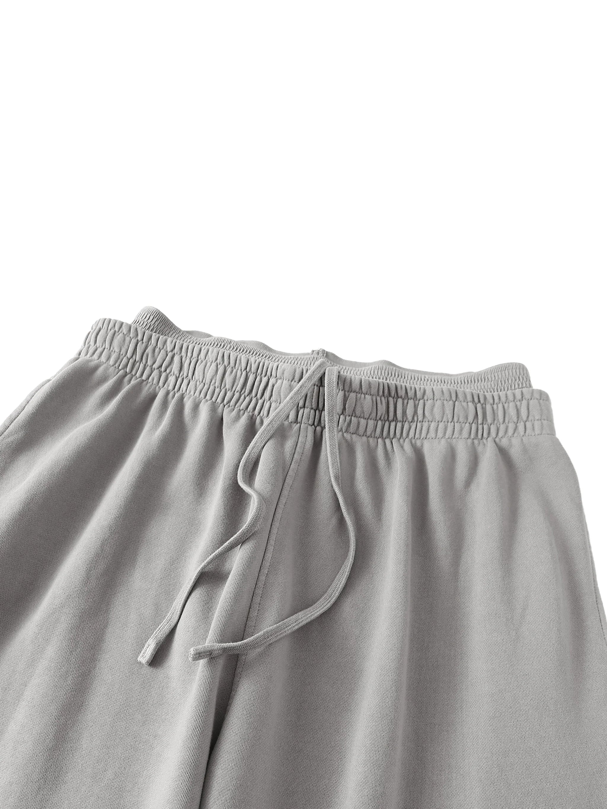 Light grey heavyweight sweat shorts with elastic waistband and drawstring, streetwear style
