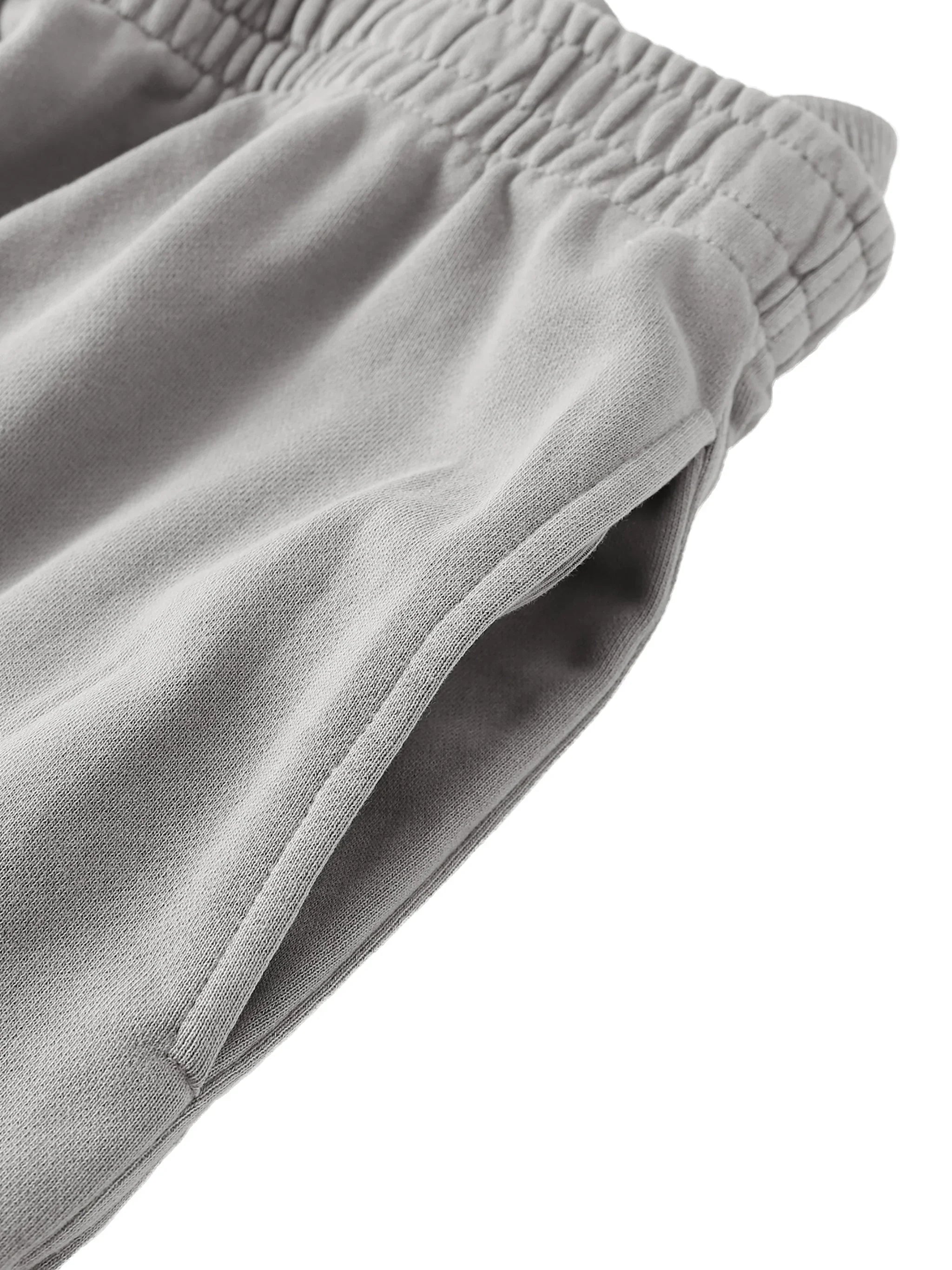 Close-up of grey heavyweight sweatshorts with elastic waistband and side pocket
