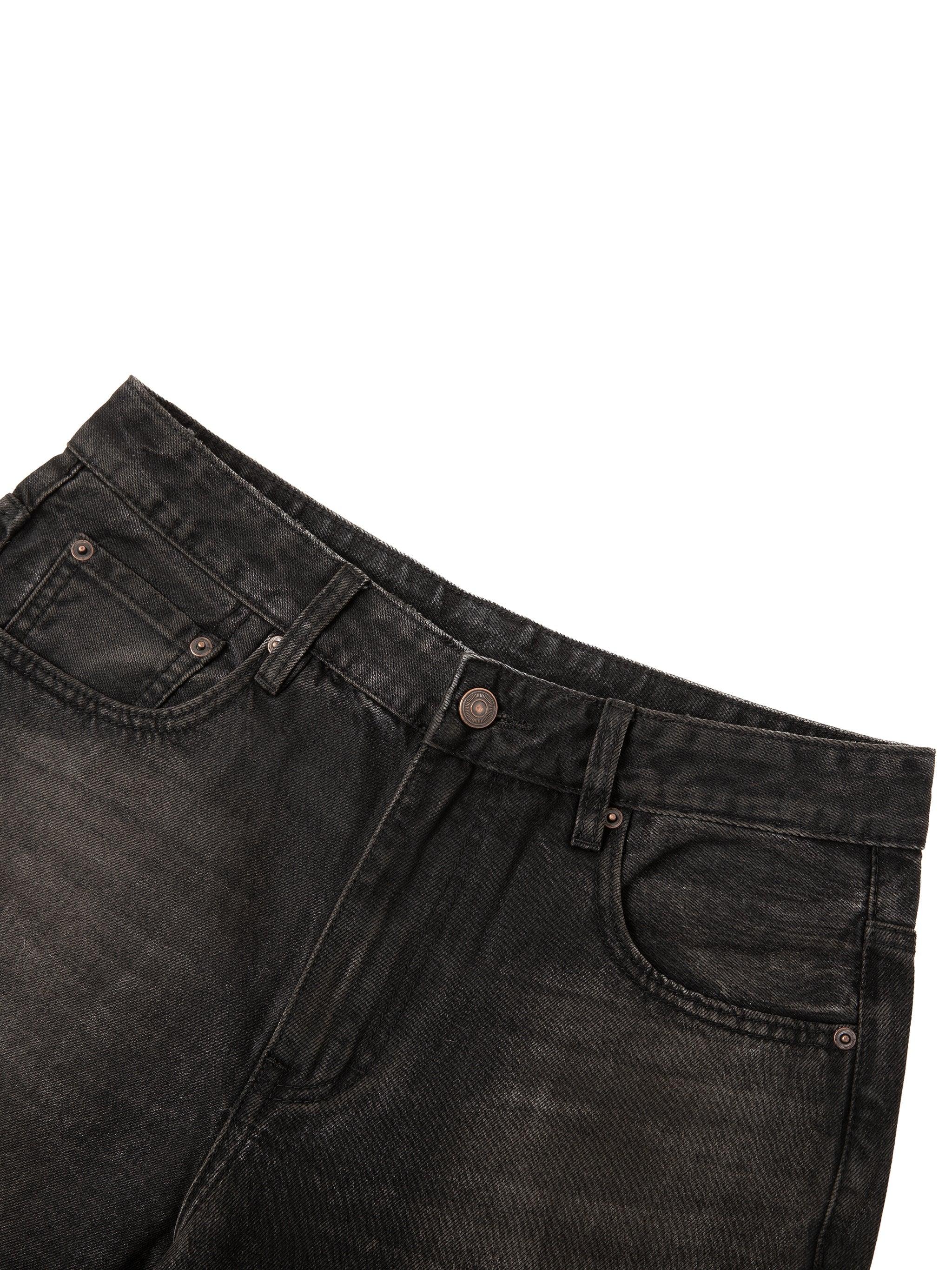 Close-up of black vintage wash denim jeans with front pockets and belt loops